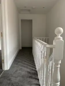 Top landing after all stained and varnished woodwork painted white satin